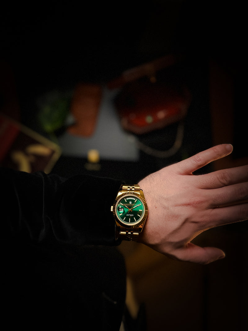 9 o'clock crown watch with golden color and green sunburst dial