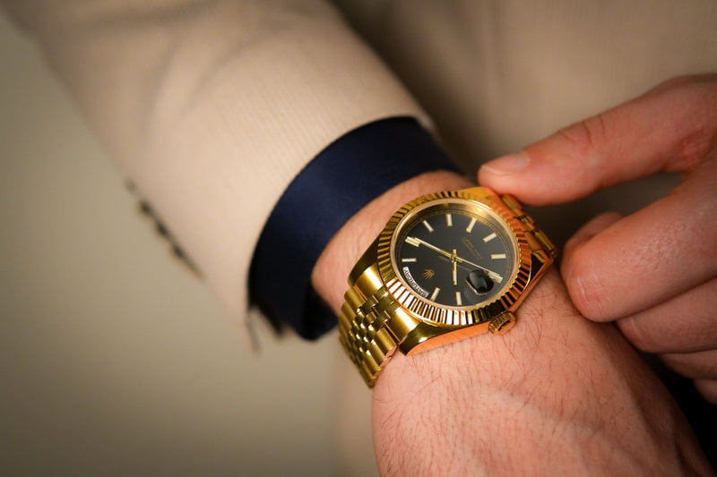 Lifestyle shot of the Valenne 9 o'clock crown watch with background of a navi sleeve, highlighting the fluted bezel.