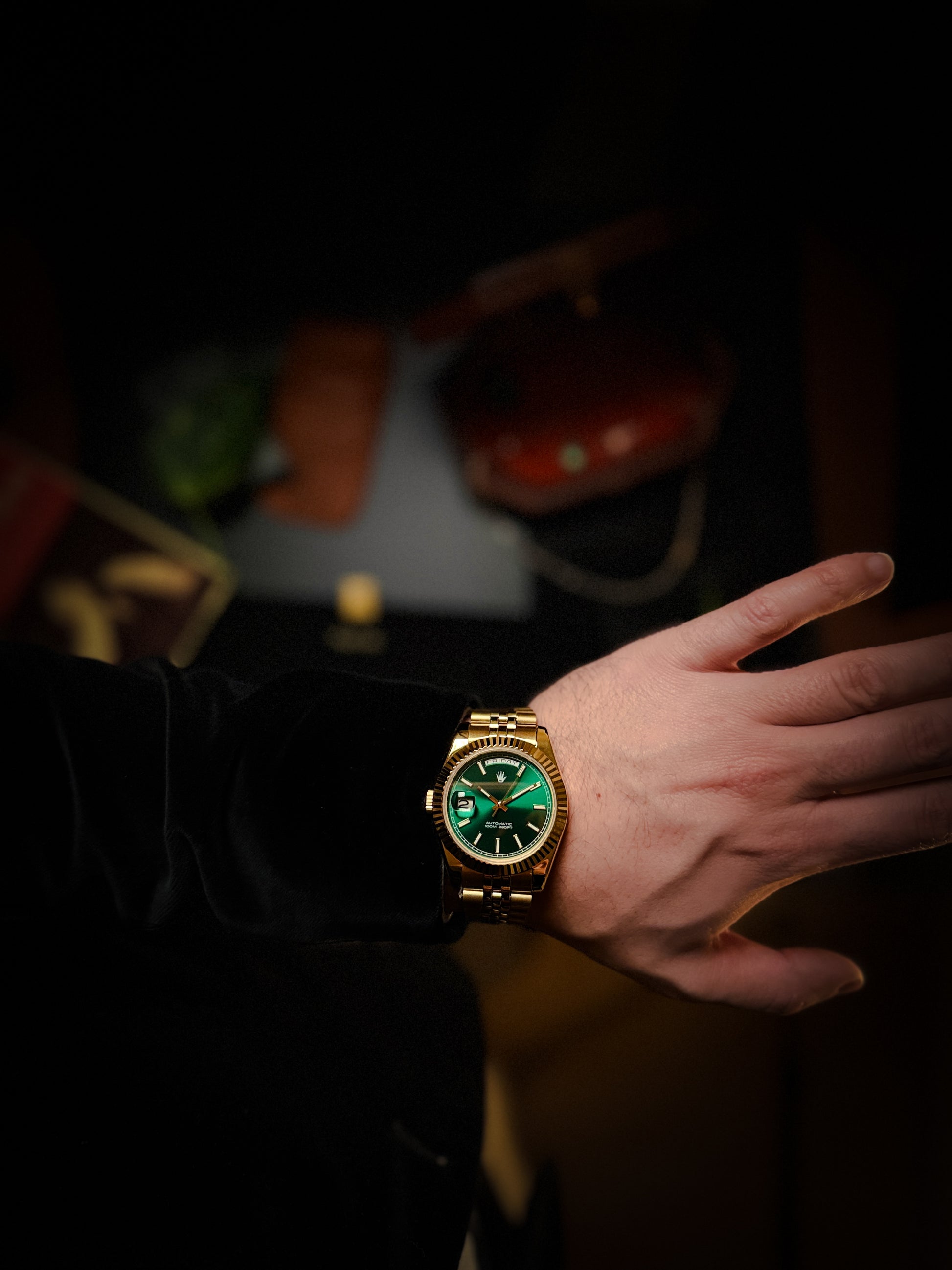9 o'clock crown watch with golden color and green sunburst dial