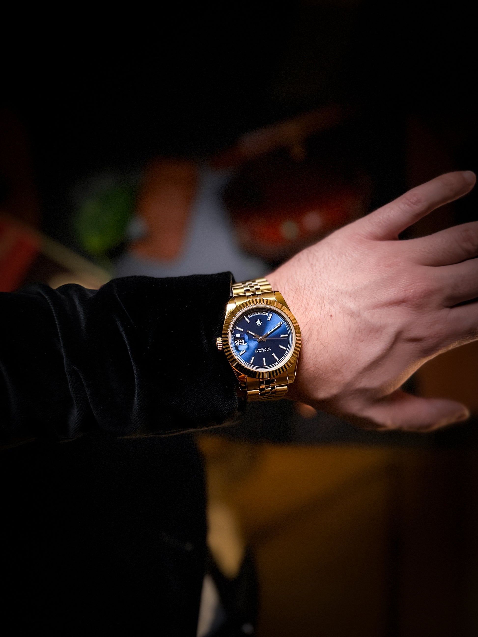 Destro Gold Watch with Blue Sunburst dial on a black suit