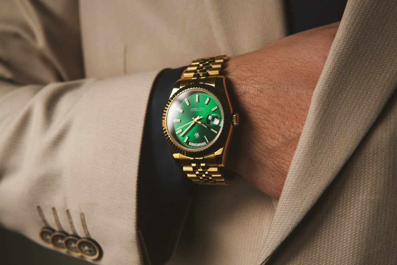 Close-up view of the Valenne left-handed watch dial and cyclops magnifier styled with a beige suit.