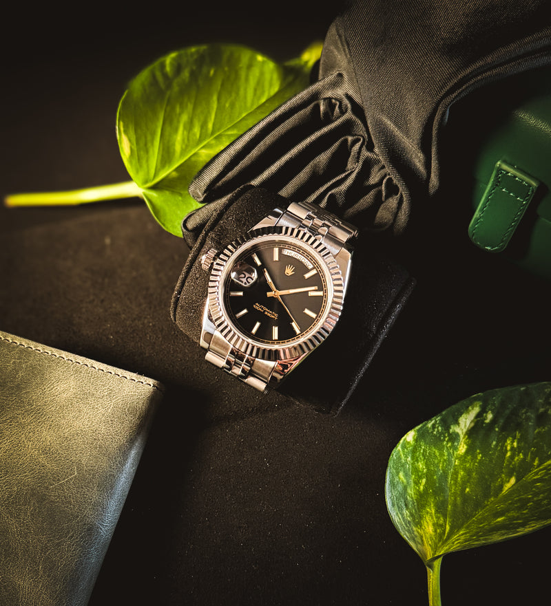 Close-up on wrist of the Valenne Destro watch showcasing the fluted bezel, cyclops magnifier, and gold-tone hands.