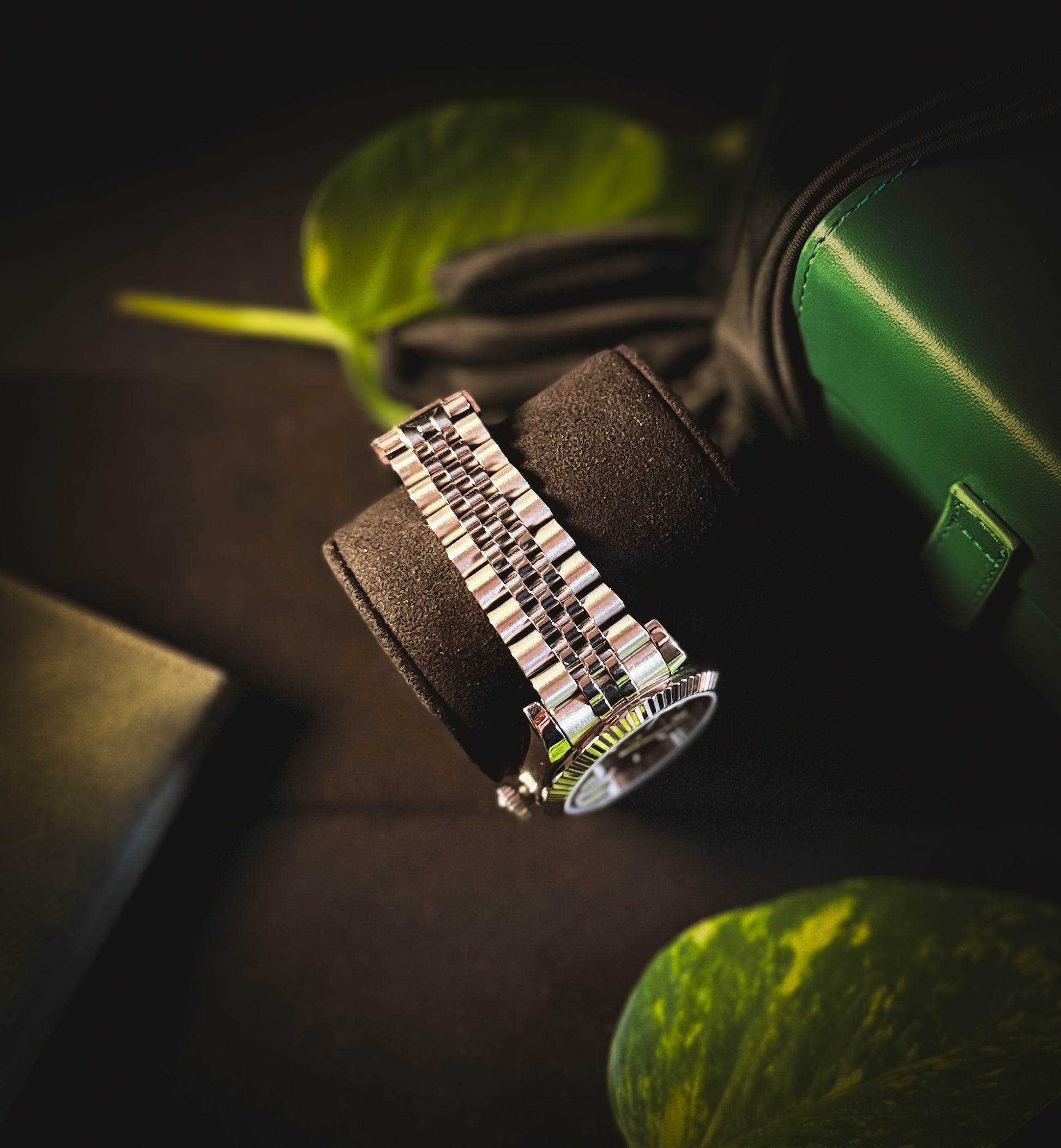 Side profile of the Valenne Destro watch on a black display pillow, focusing on the brushed and polished steel bracelet.
