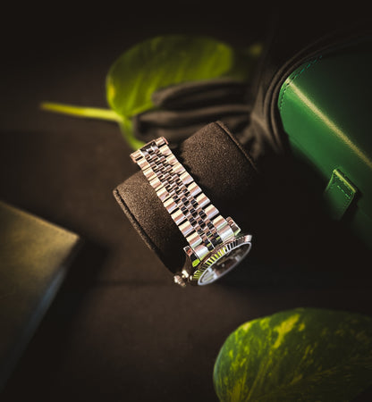 Side profile of the Valenne Destro watch on a black display pillow, focusing on the brushed and polished steel bracelet.
