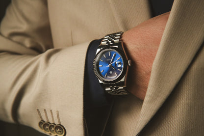 Man in a light suit wearing the Valenne left-handed watch on his left wrist, demonstrating ergonomic comfort.