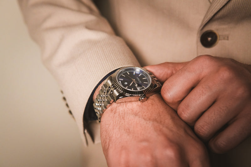 Full view of the Valenne left-handed automatic watch featuring a steel case, navy dial, and jubilee bracelet.
