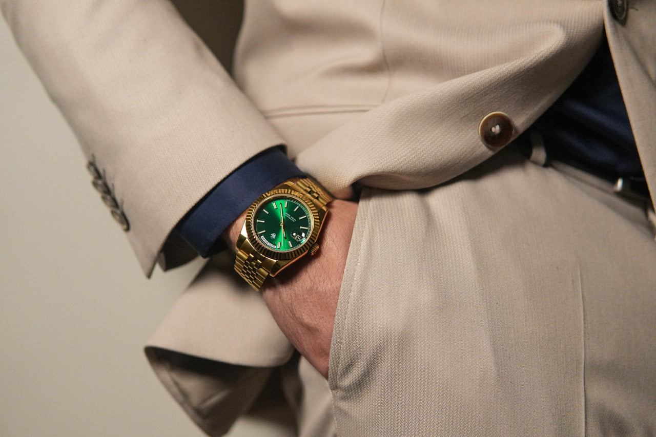 Classic lifestyle portrait of the Valenne 9 o'clock crown watch paired with a tailored beige suit.
